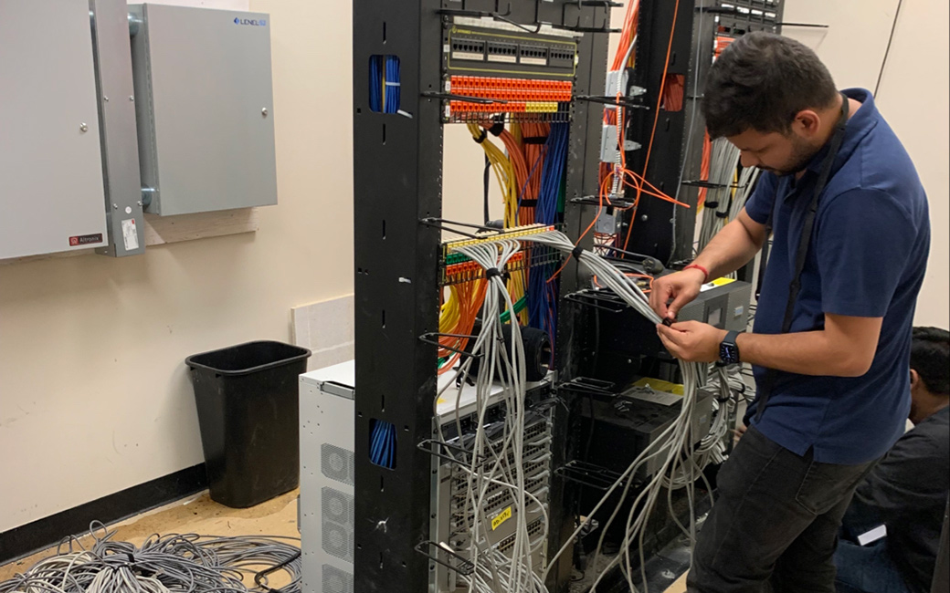 Man working on network wires and system