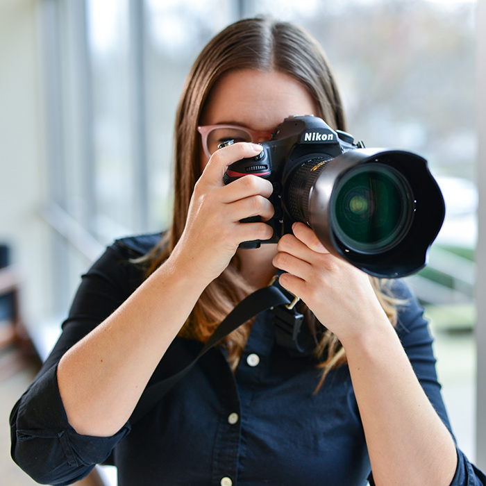 TU employee with a camera