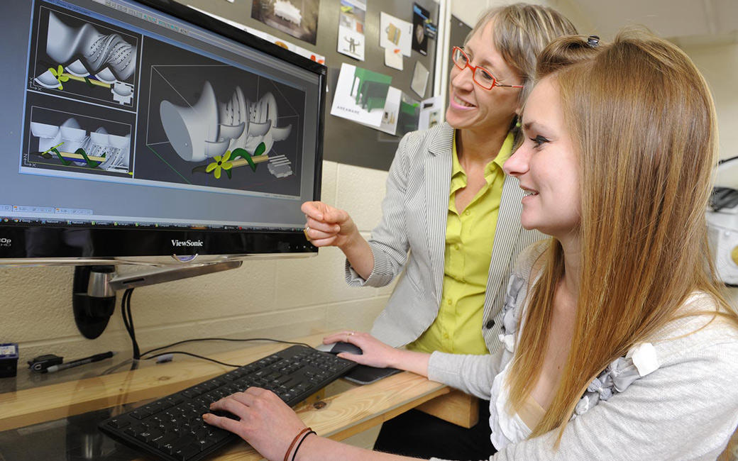 Student and professor working on computer model