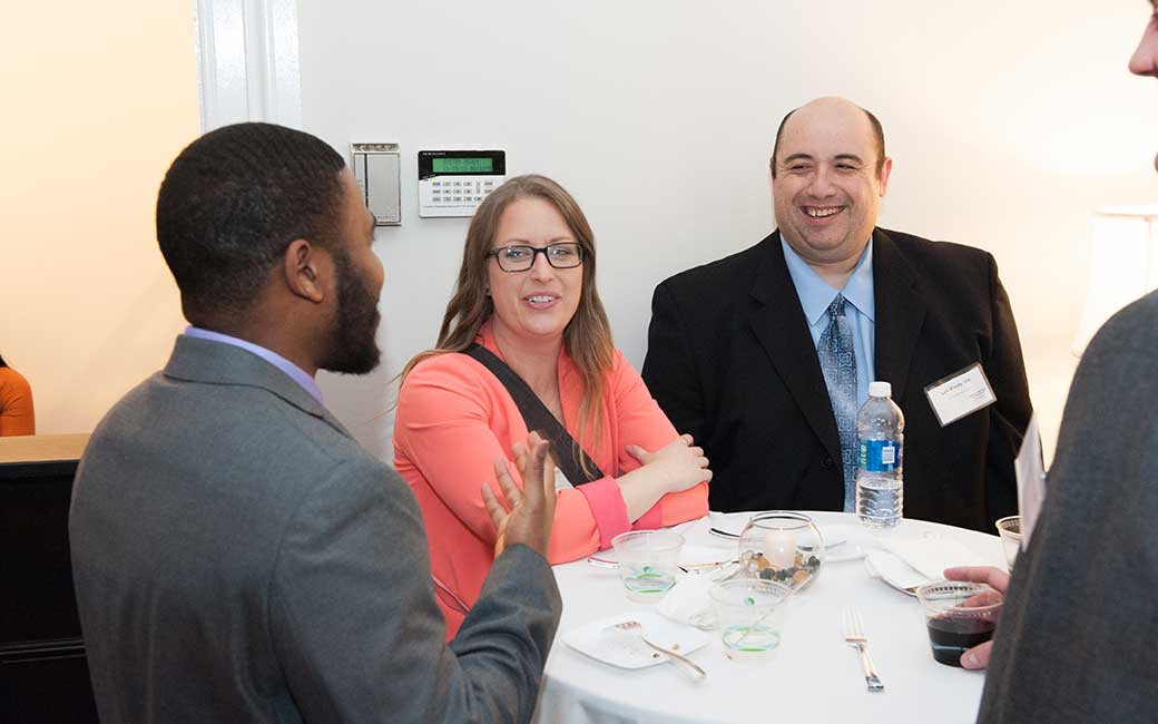 alums chatting at a networking event