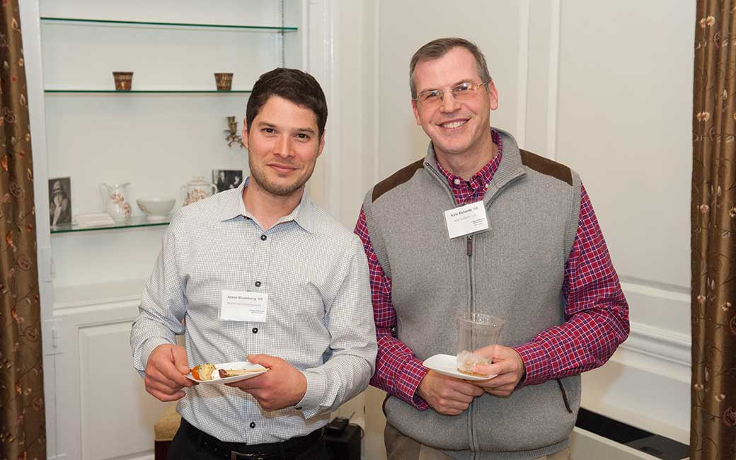 two accounting alums smile at the networking event