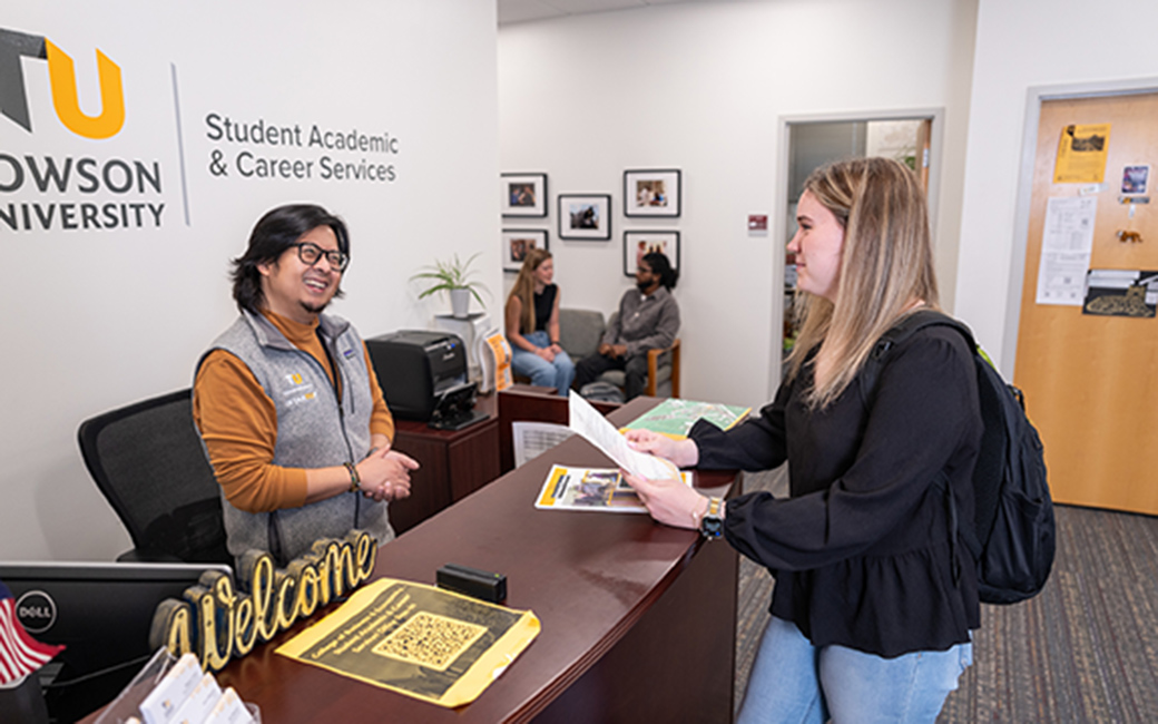 advisor greets student in SACS