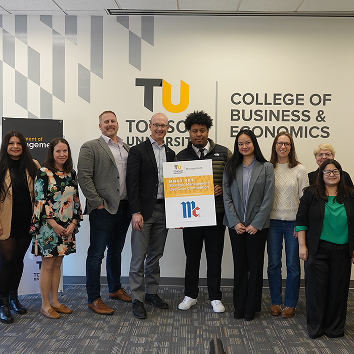 Students pose with faculty and business representatives