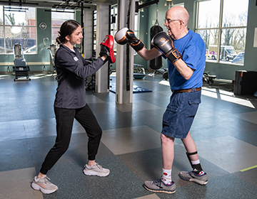 Caitlin Berger and a participant enjoying Rock Steady Boxing