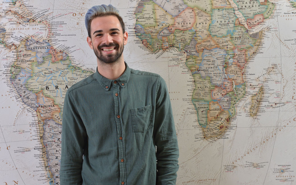 Frankie Panebianco standing in front of a map