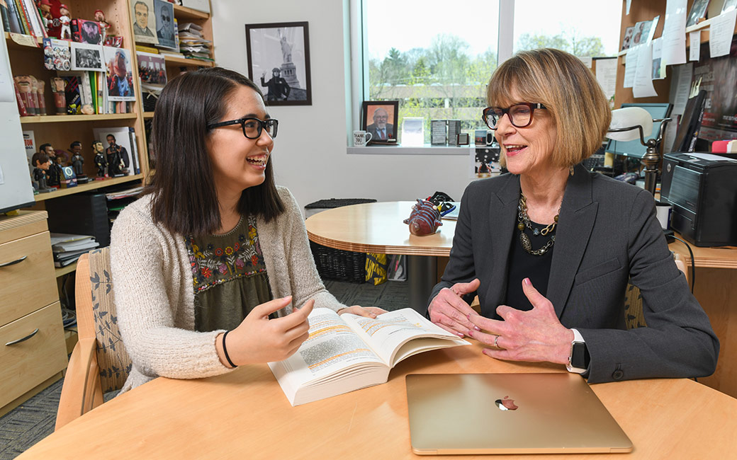Summer Hagelin speaking with a faculty member