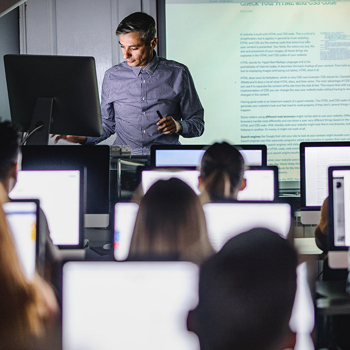 Teacher teaching to a class using technology