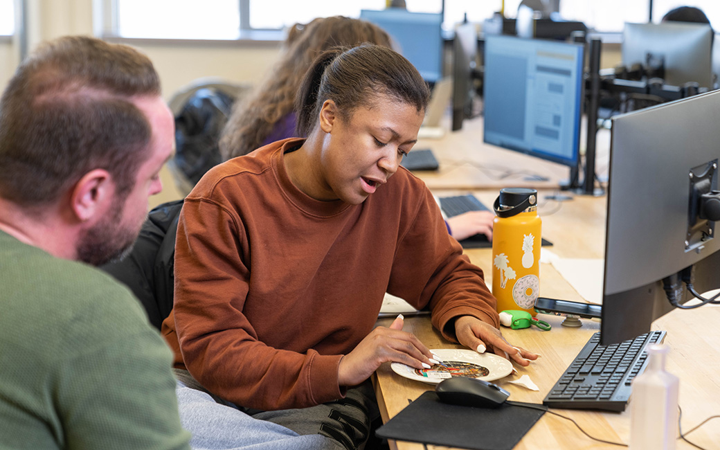 faculty member and student working in the digital object lab