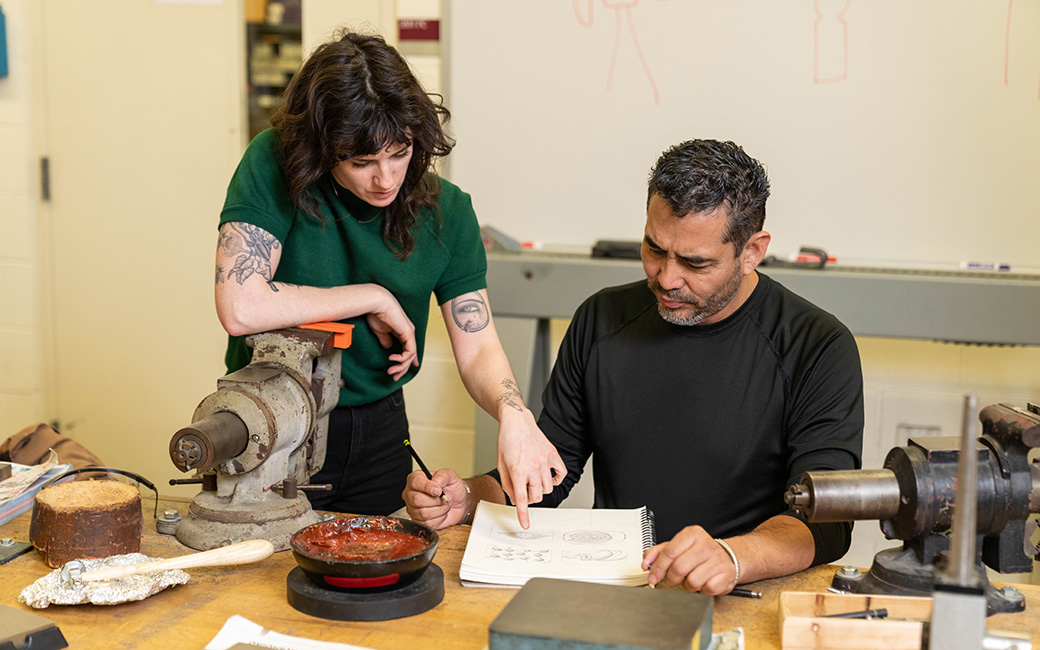 facullty member and student working in metals and jewelry studio 