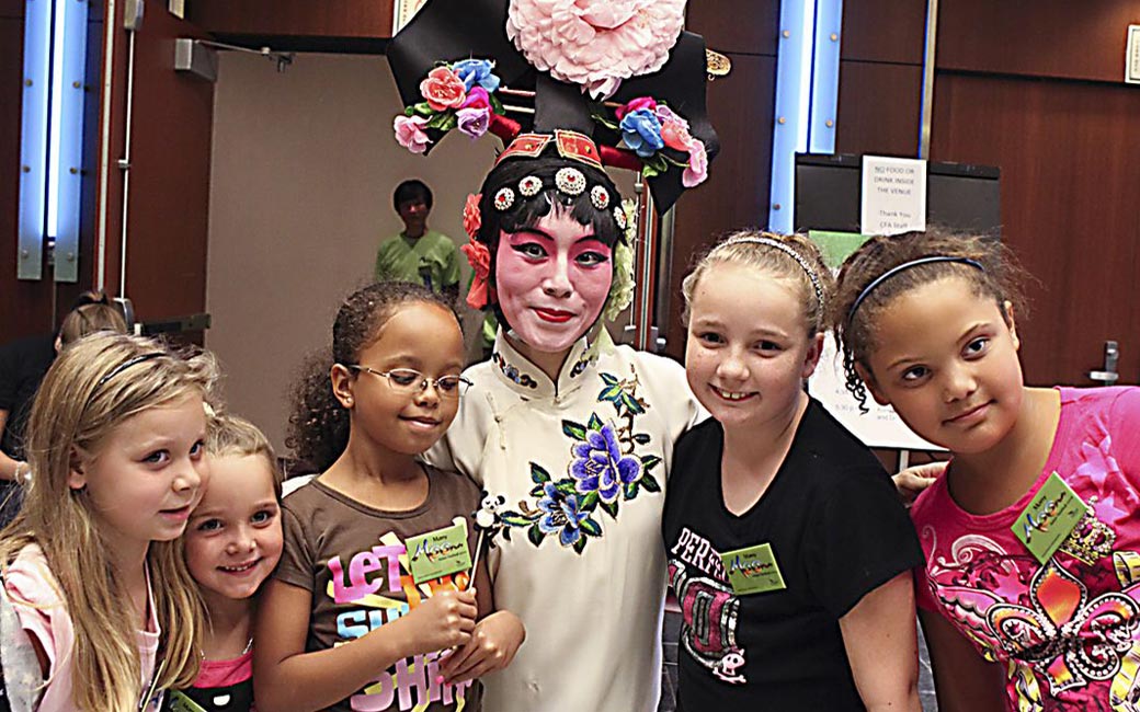 Children with a performer at the Asian Arts and Culture Center's Many Moons Festival in 2010