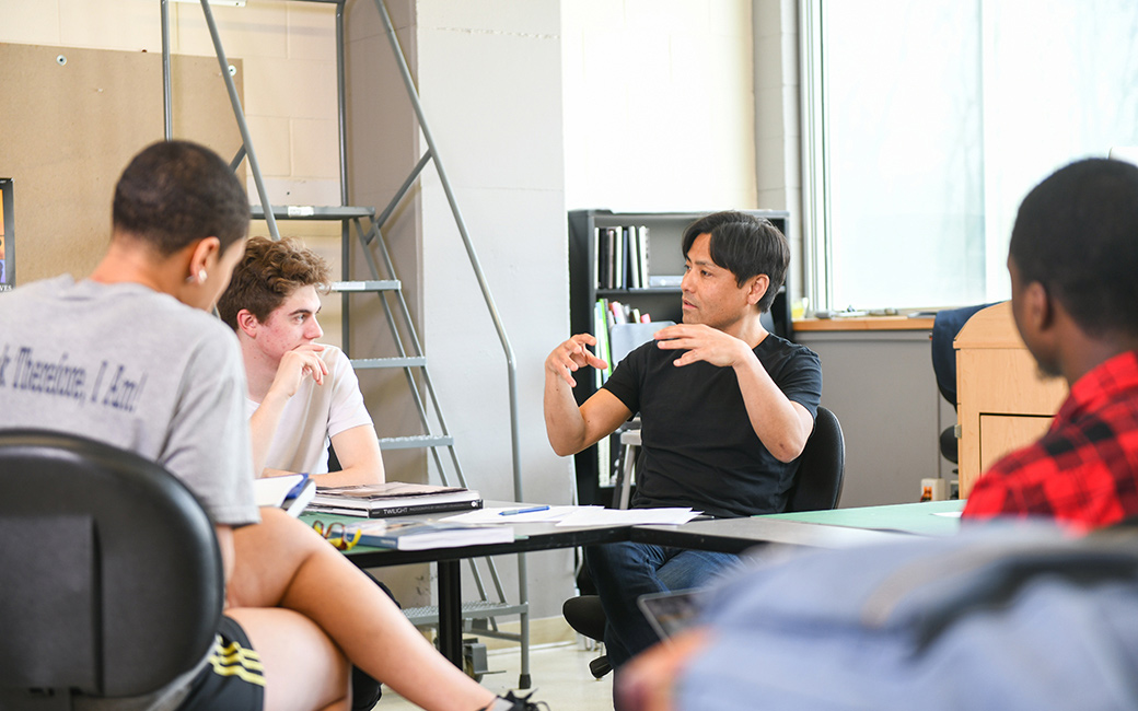 faculty and students in discussion in photography studio