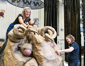 Professor Tavia Lafollette and a student working on set design