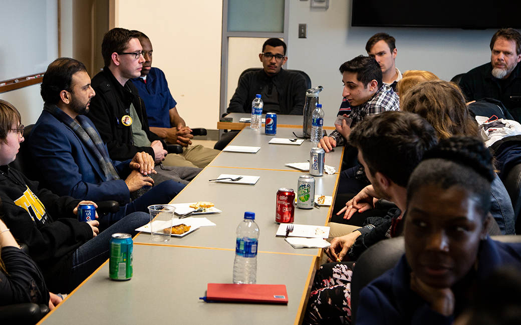 Qasim Rashid speaking with TU students