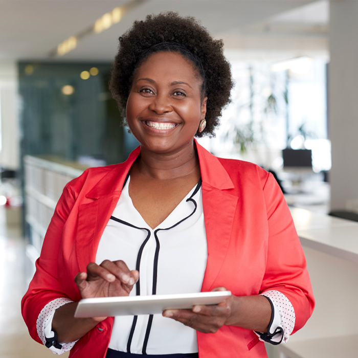 A woman on a tablet smiling 