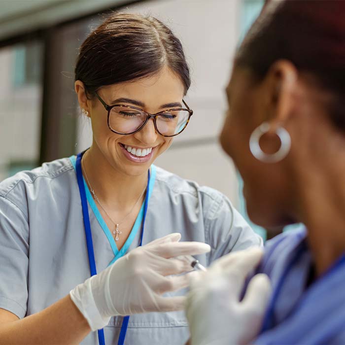 Medical assistant giving an injection