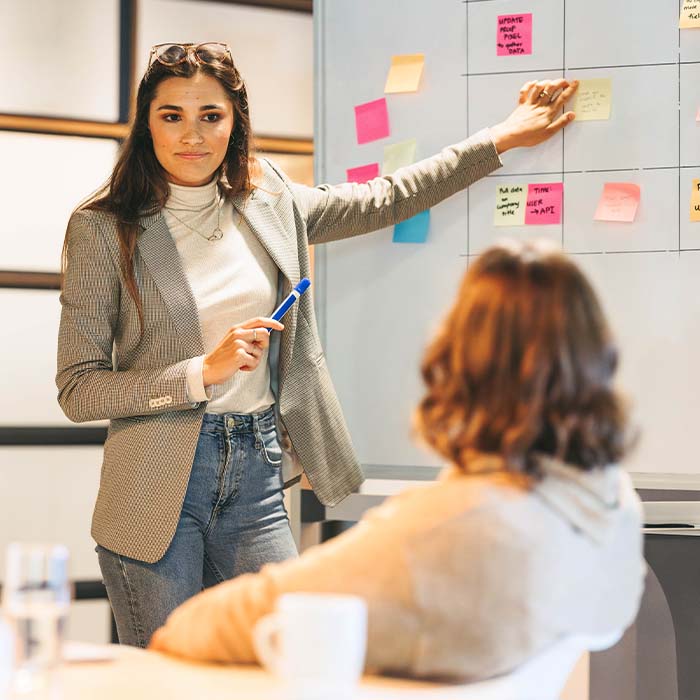 younger woman in the office leading a project