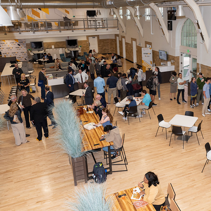 overhead photo of many people working and meeting in the shared workspace