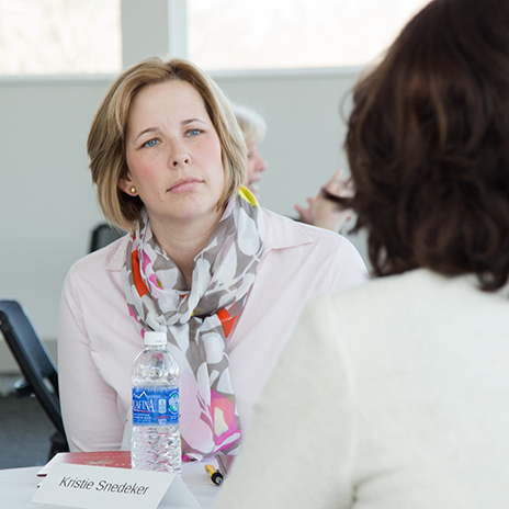 Photo of Kristie Snedeker seated at a women's leadership event