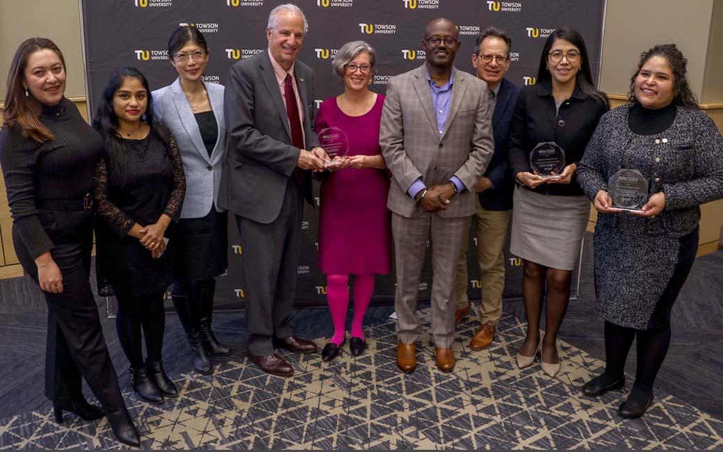 president ginsberg poses with baltimore immigration summit award winners