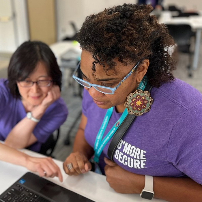 Gencyber women looking at computer