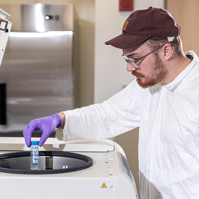 Zachary Greenwald centrifuging a water sample