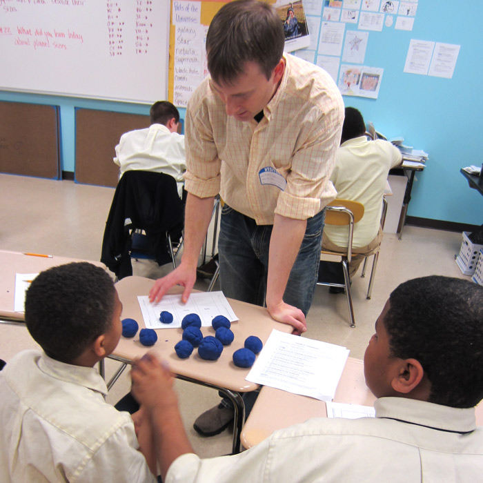 teacher working with young students