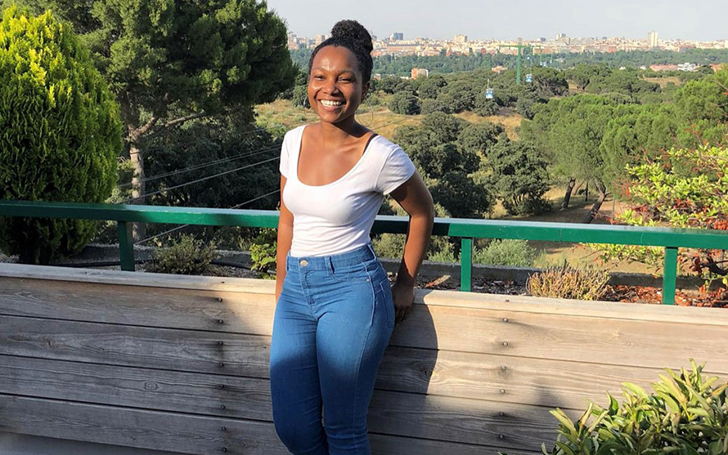 Honors student standing in front of Madrid skyline