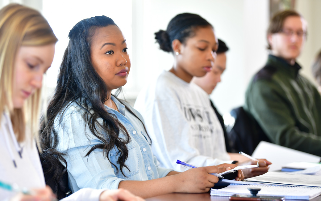 Honors students, including international student, sitting in classroom