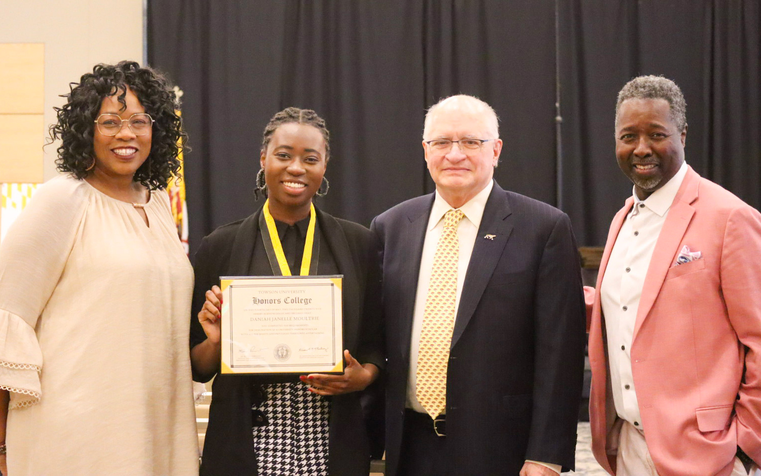 Honors graduate Daniah Moultrie with her parents and Dr. Terry Cooney at Honors Convocation