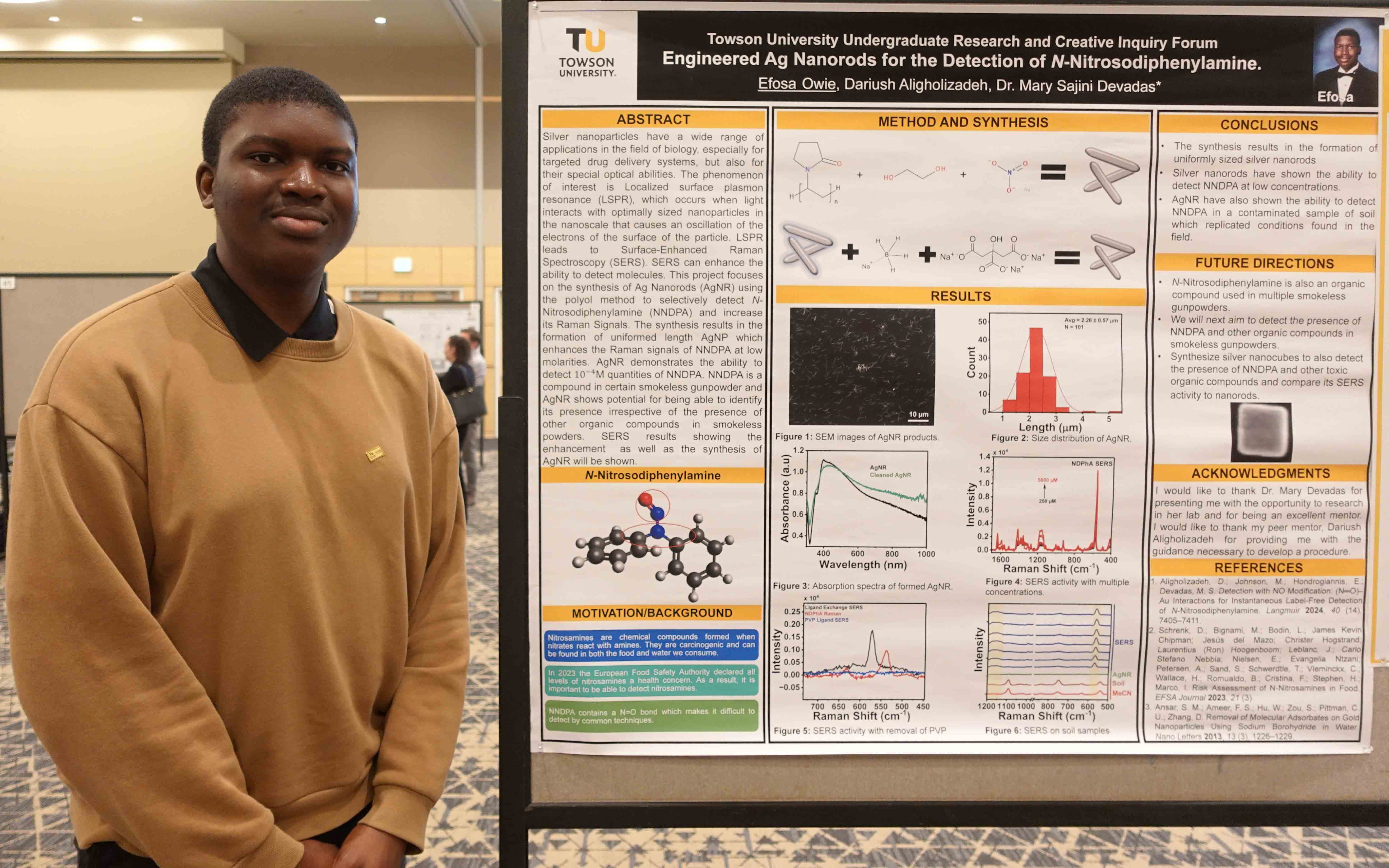 Honors student Efosa Owie standing beside research at a campus poster conference
