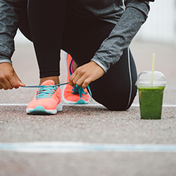 Image of runner tying shoes