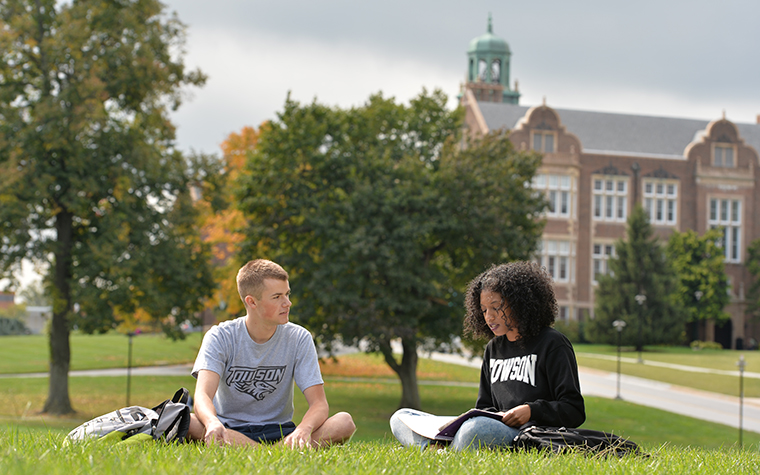 Students sitting outside of Towson University studying