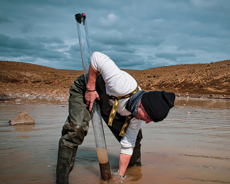 Mike Thorpe taking a rock core sample