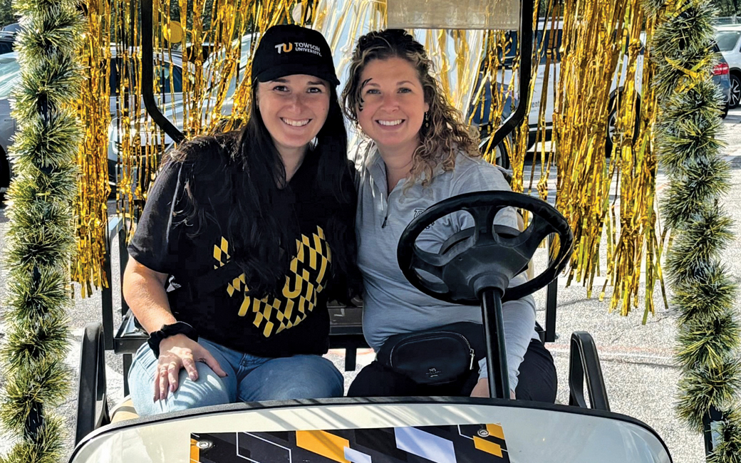 Courtney Slemp and Jenna Mills distributed T-shirts and other giveaways to tailgaters via the Alumni Swag Wagon.