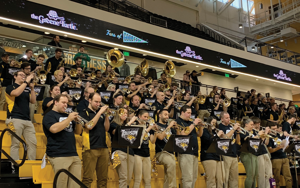 Former and current band members play alongside each other during the game.
