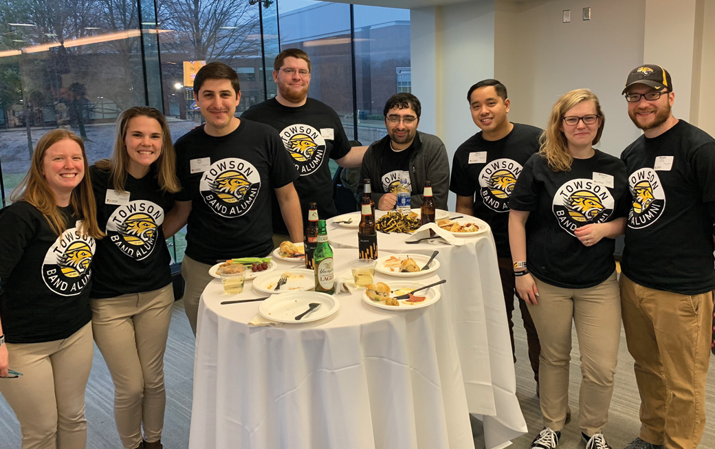 Marching band alumni catch up at a postgame reception.