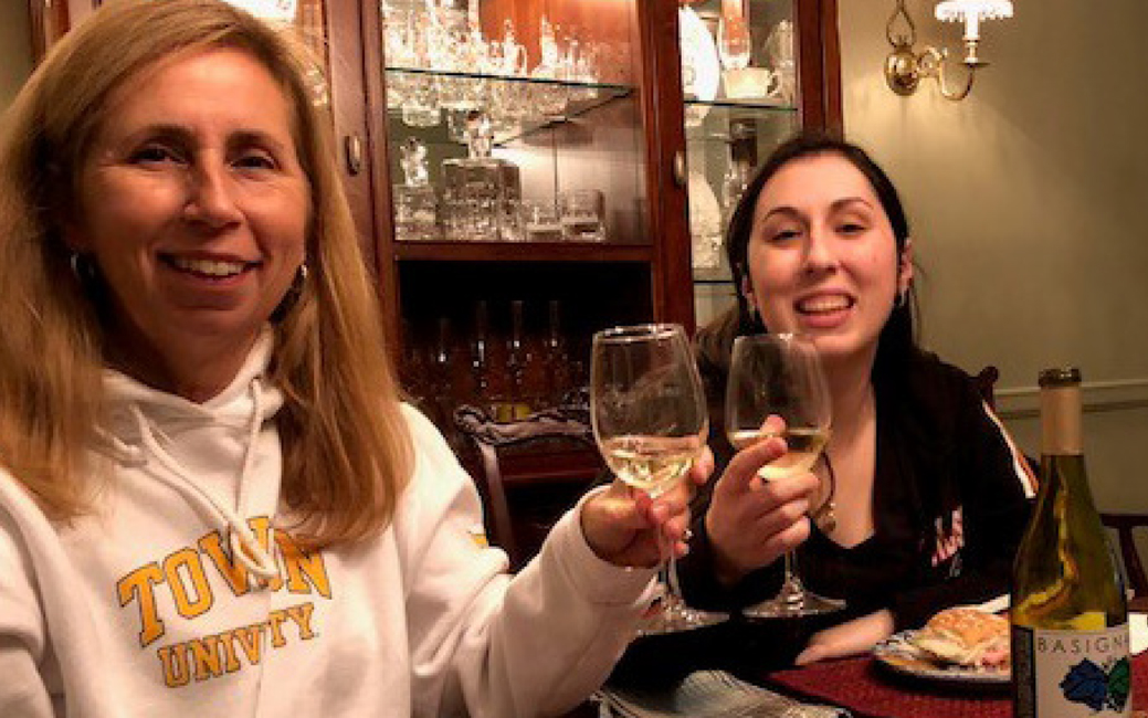 Two people holding wine glasses