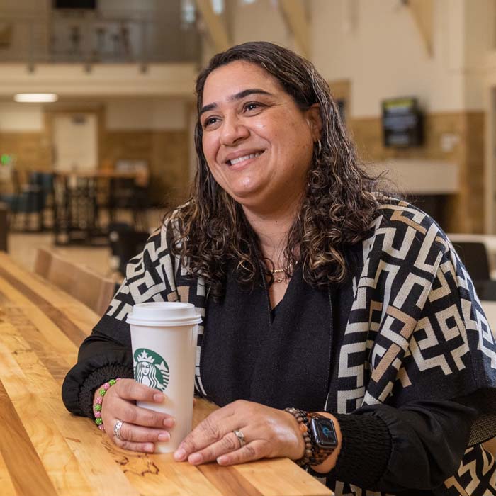 Patricia Bradley sitting with a cup of coffee