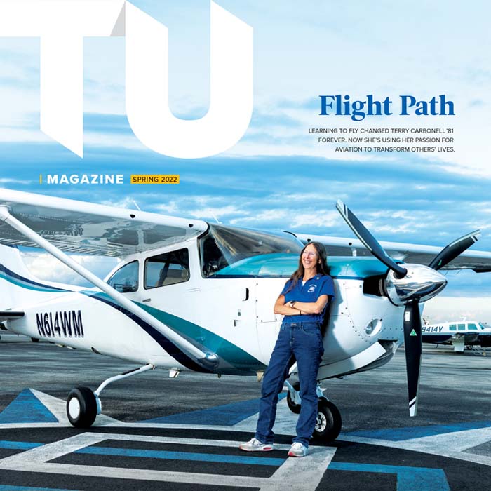 Terry Carbonell next to her plane on the cover of the magazine