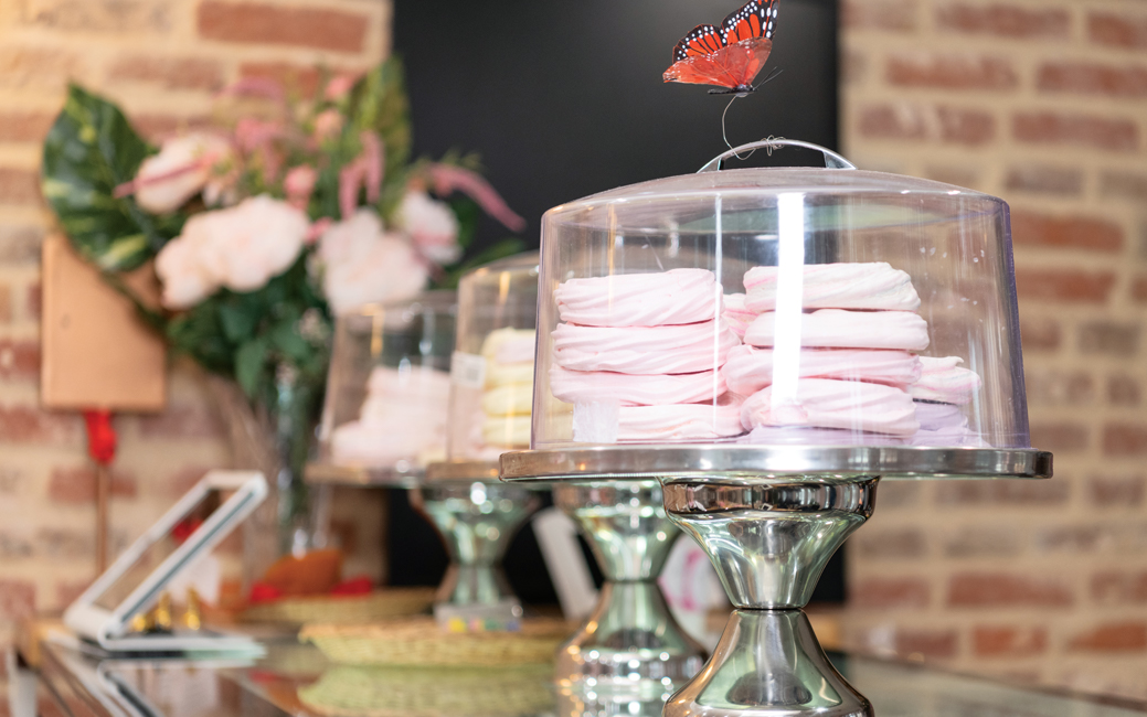 Glass domes containing pink meringues