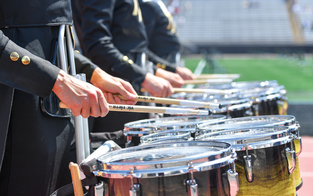Close up shot of drumline drums, hands and drumsticks