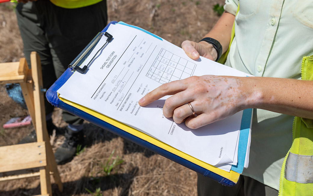 Pointing at paper on clipboard