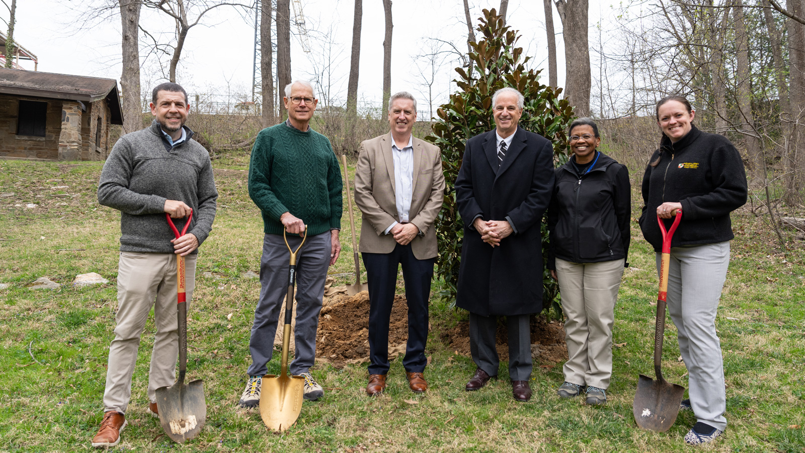 Members of facilities, James Hull, Fisher College of Science Mathematics Dean, Matthew Nugent and President Mark Ginsberg stand in front of the Southern Magnolia Tree planted for Maryland Arbor Day. 