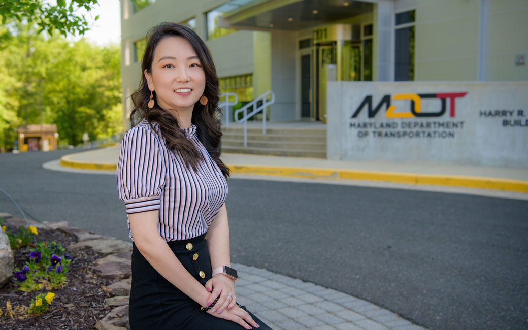 Alumna sits outside of Maryland Department of Transportation headquarters