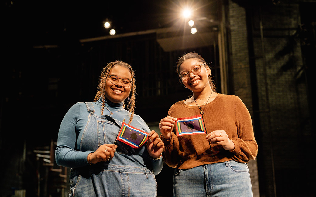 Two women holding a small flag