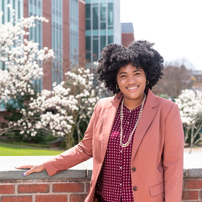 Portrait with blooming trees in background