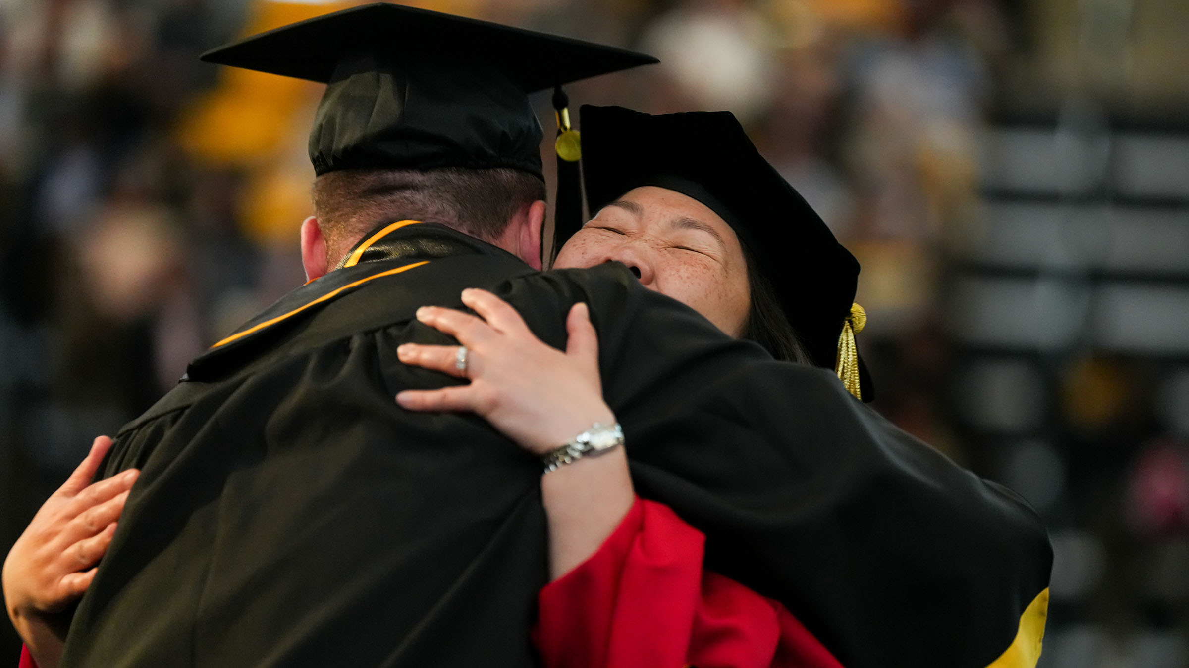 TU student graduate hugging a faculty member