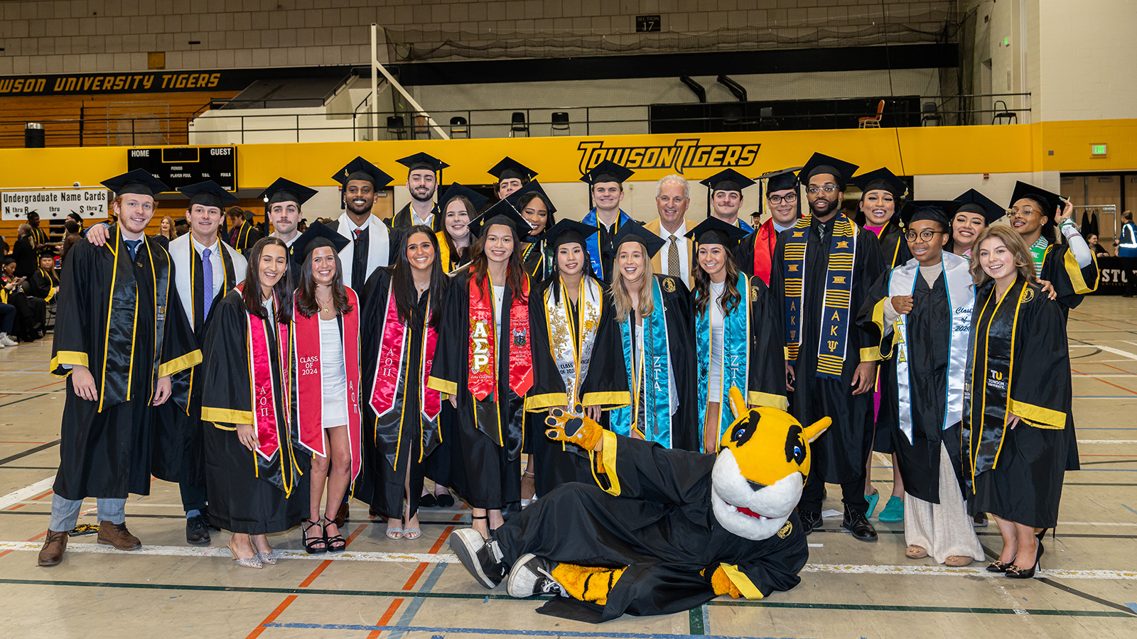 president ginsberg poses with students at commencement