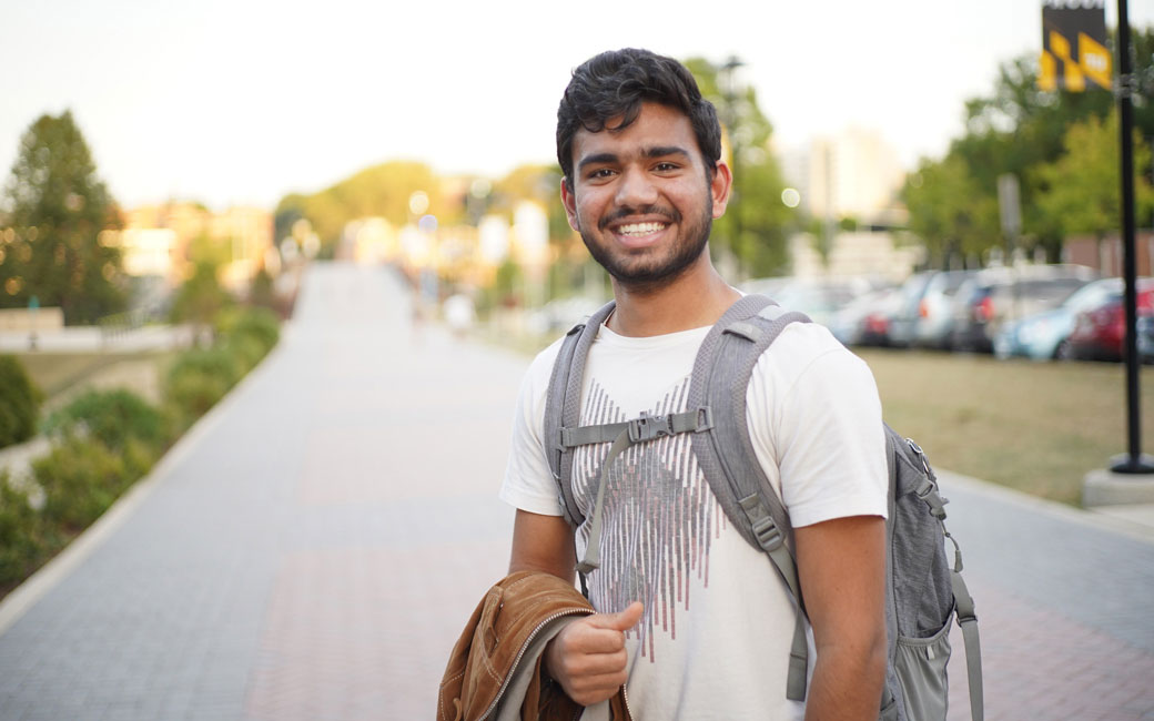 student poses on campus