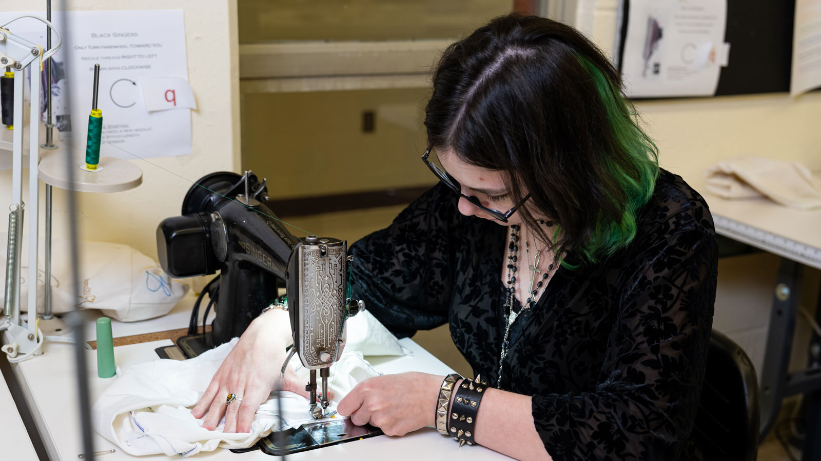 Student sews lining for costume